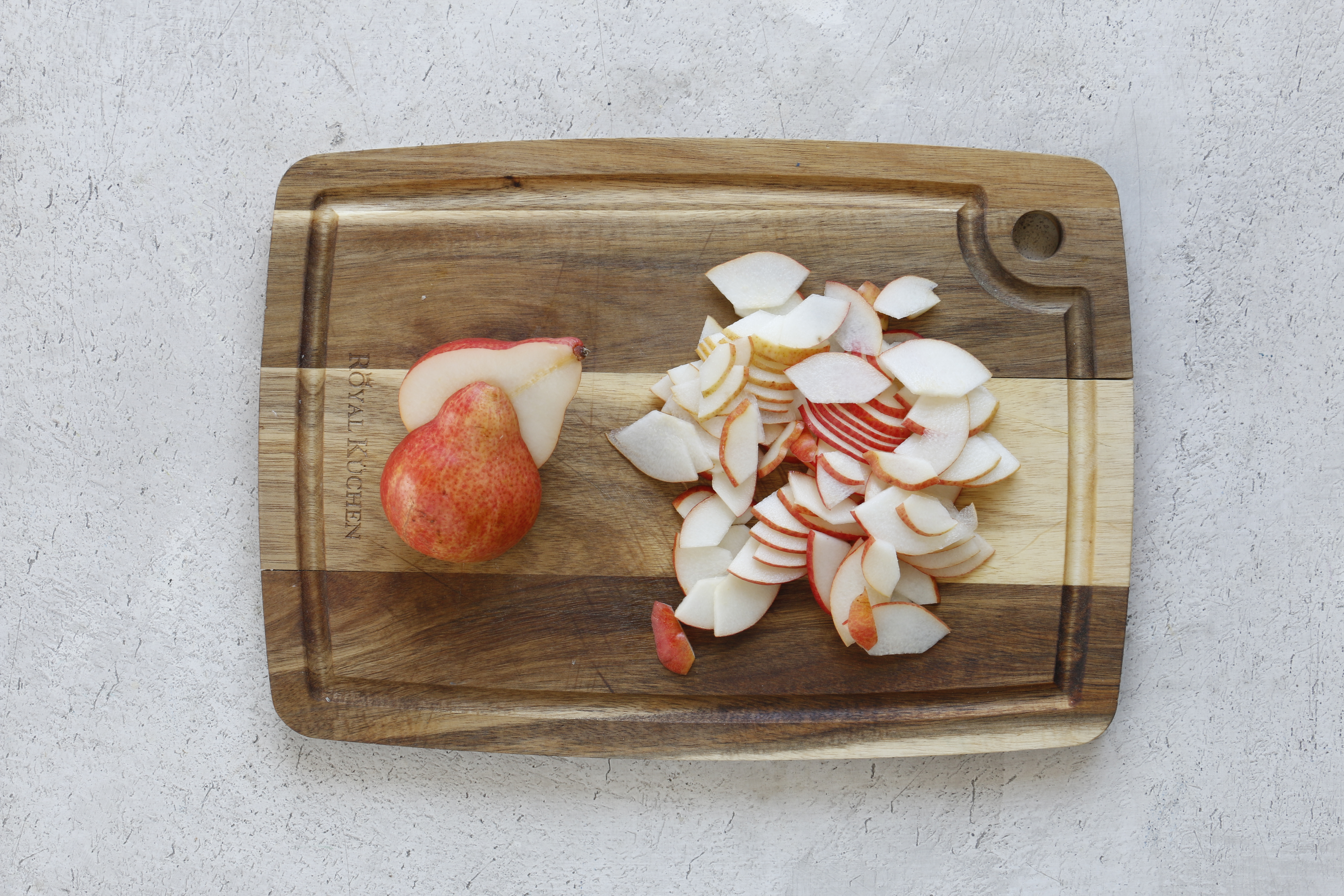 Грушу разрежьте на четвертинки, удалите сердцевину, мякоть нарежьте поперек тонкими ломтиками.