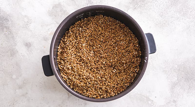 Влейте теплую питьевую воду. Немного посолите. Закройте мультиварку. Включите режим «Тушение» или «Выпечка». Гречка с курицей должна готовиться в течение часа.