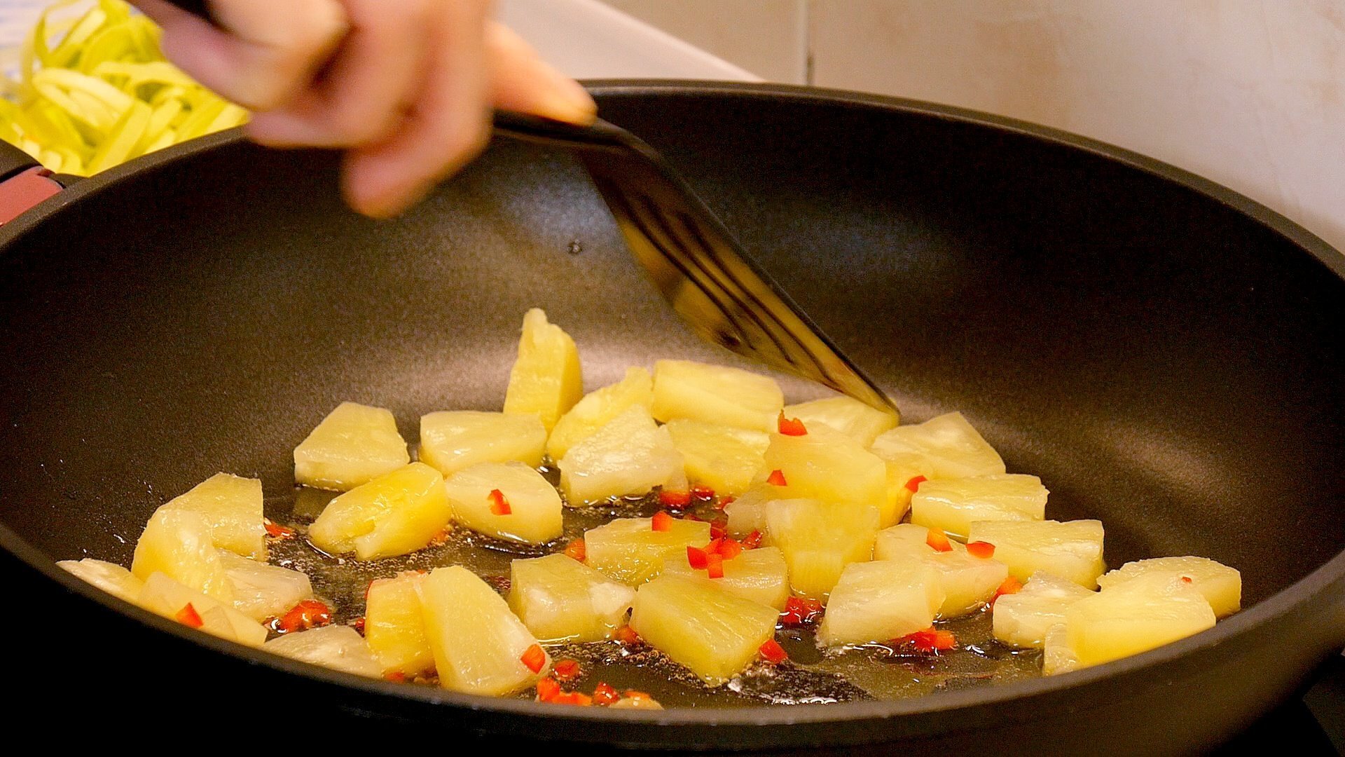 Пока мясо маринуется, обжариваем на растительном масле ананасы. Вынимаем ананасы, в этом же масле обжариваем мясо с двух сторон до образования корочки так, чтобы кусочки не слипались.