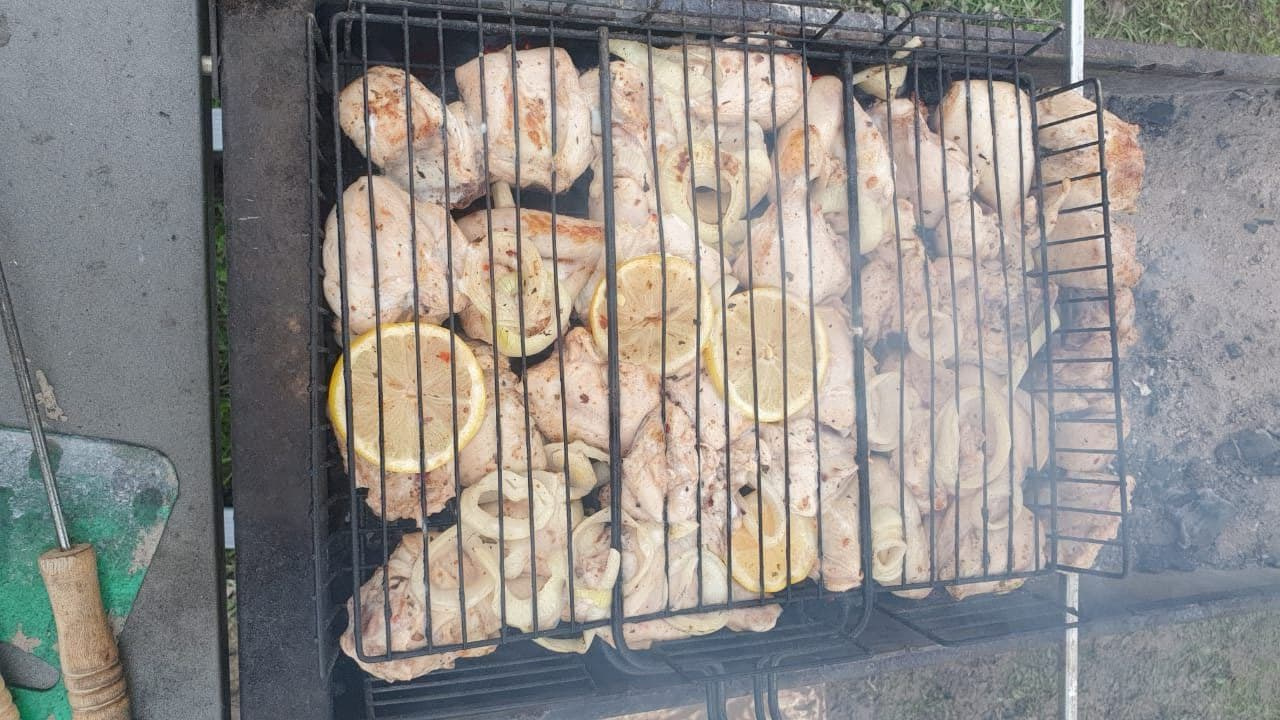 Режем лимон и лук кружочками. Укладываем куриные бедраслоями, перемежая их с лимоном и луком. Заливаем минералкой. Оставляем куриные бедра в маринаде от 2 до 8 часов. Когда выкладываем на гриль, сверху на бедрышки кладём лук и лимон, которые были в марина