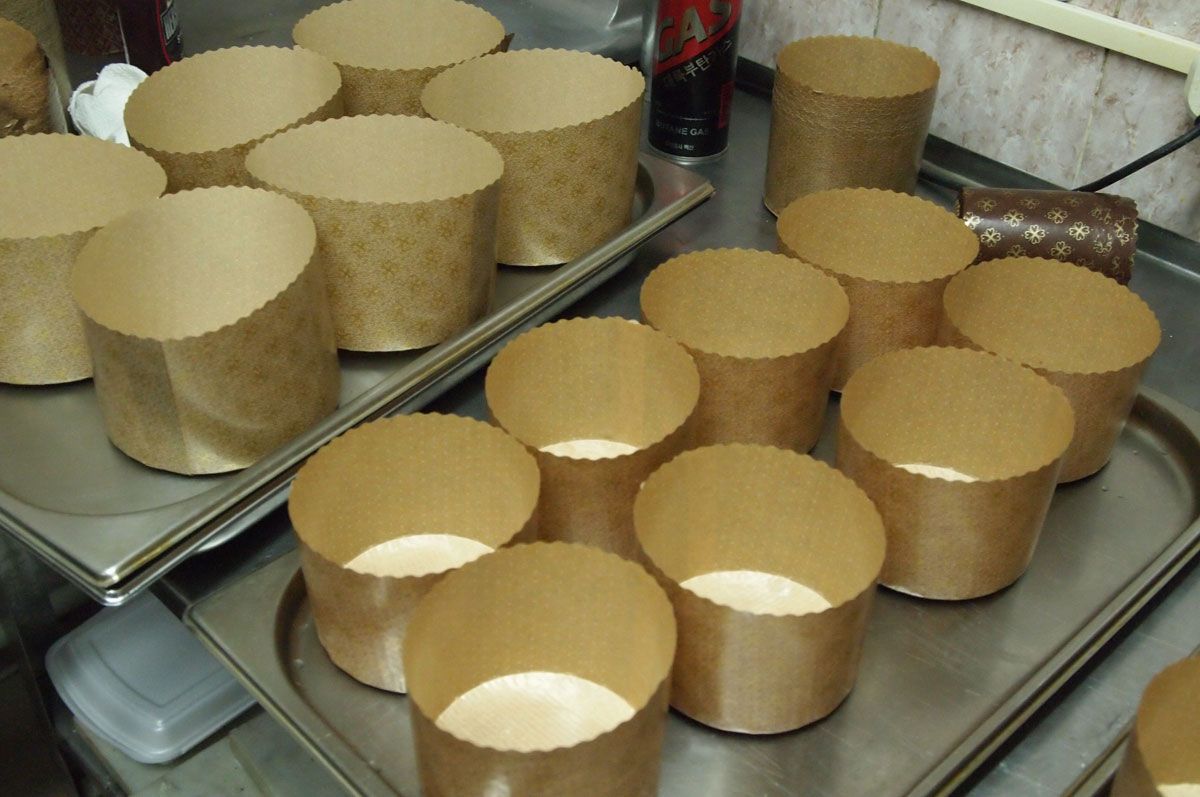 Подготовьте формы для куличей. Вырежьте из бумаги для выпечки круги по диаметру донышек и смажьте с обеих сторон кокосовым маслом. Помесите внутрь форм так, чтоб боковые поверхности тоже были прикрыты на 2–3 см.