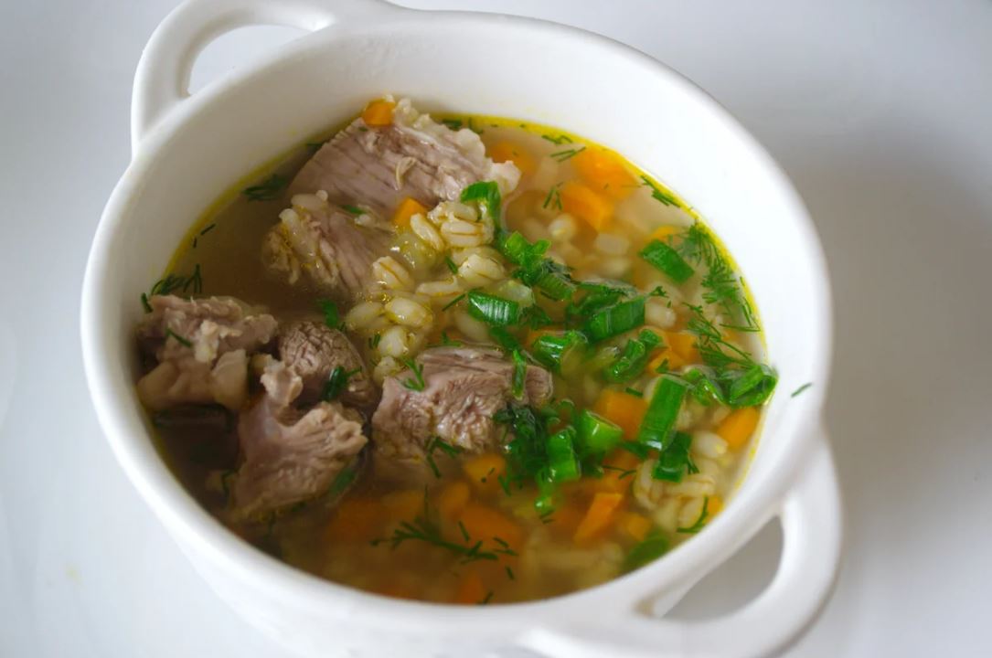 В мясной бульон опустить картофель, нарезанный кубиками вдвое крупнее овощей. Дать закипеть, затем опустить готовую крупу. Регулируйте густоту по своему вкусу, но похлебка не должна быть жидкой. Дать покипеть на медленном огне минут 10 и опустить овощную 
