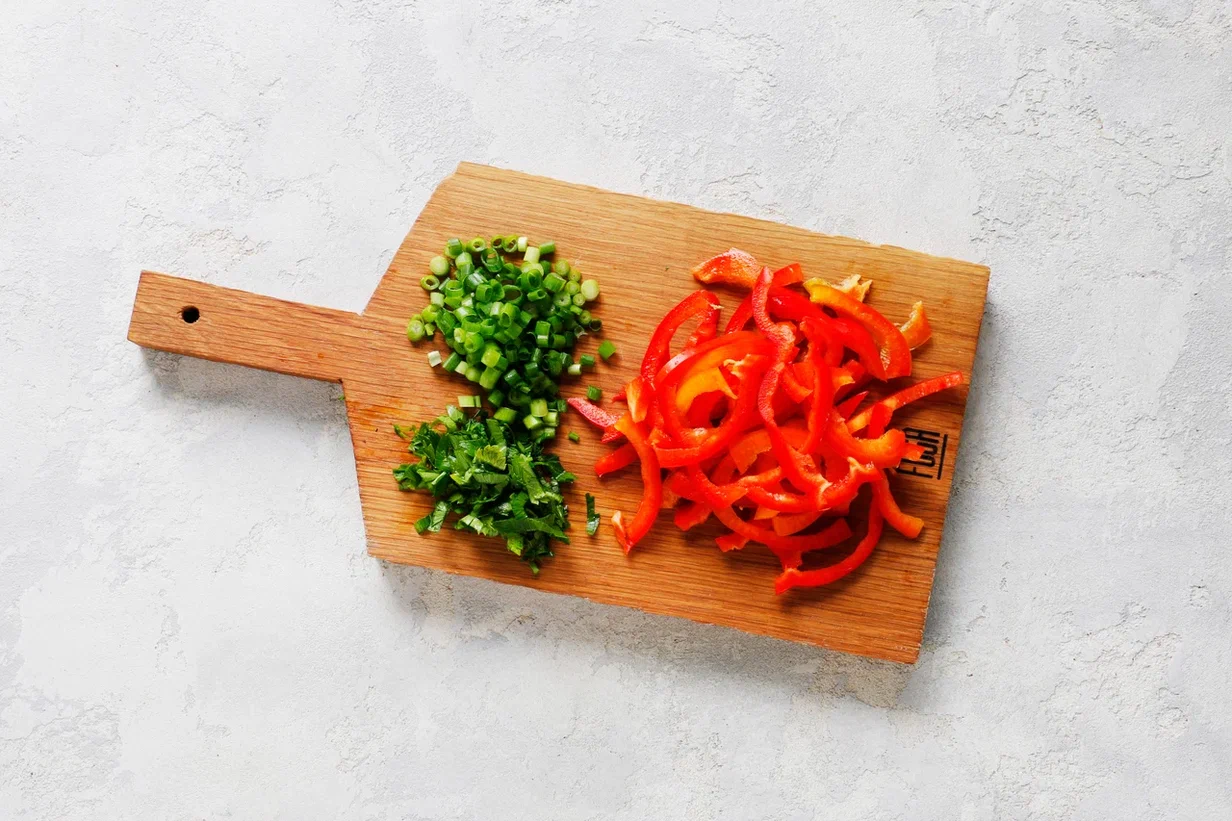 Сладкий перец вымойте и нарежьте полосками, удалив семена и перегородки. Петрушку и зеленый лук вымойте, обсушите. Мелко нарежьте. Банку с тунцом откройте, слейте жидкость.