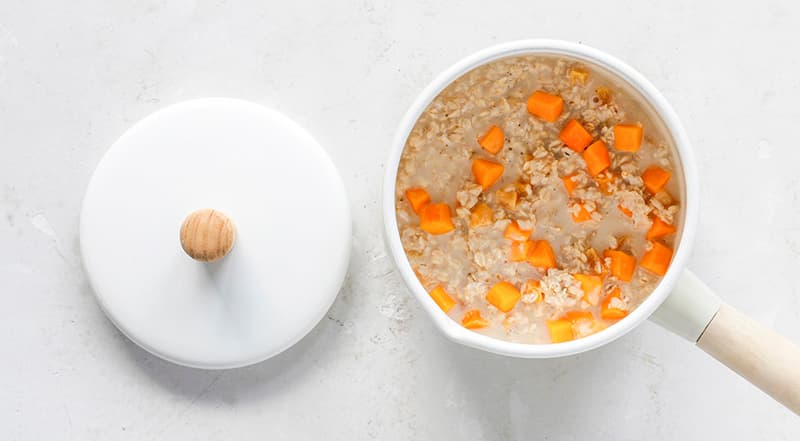 Очистите тыкву и нарежьте кубиками примерно 1,5 см. Добавьте тыкву в овсянку, перемешайте, закройте, готовьте еще 10 мин.