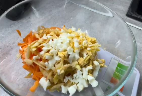 На крупной тёрке натереть морковь и яблоко, отварное яйцо порезать кубиками.